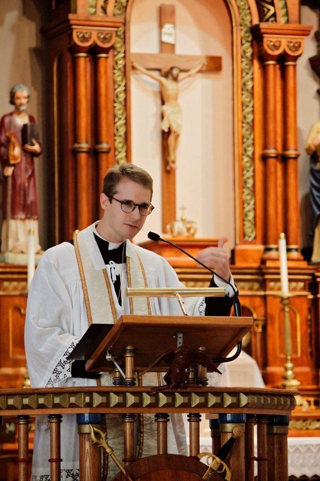 Father Harkins giving his homily during mass