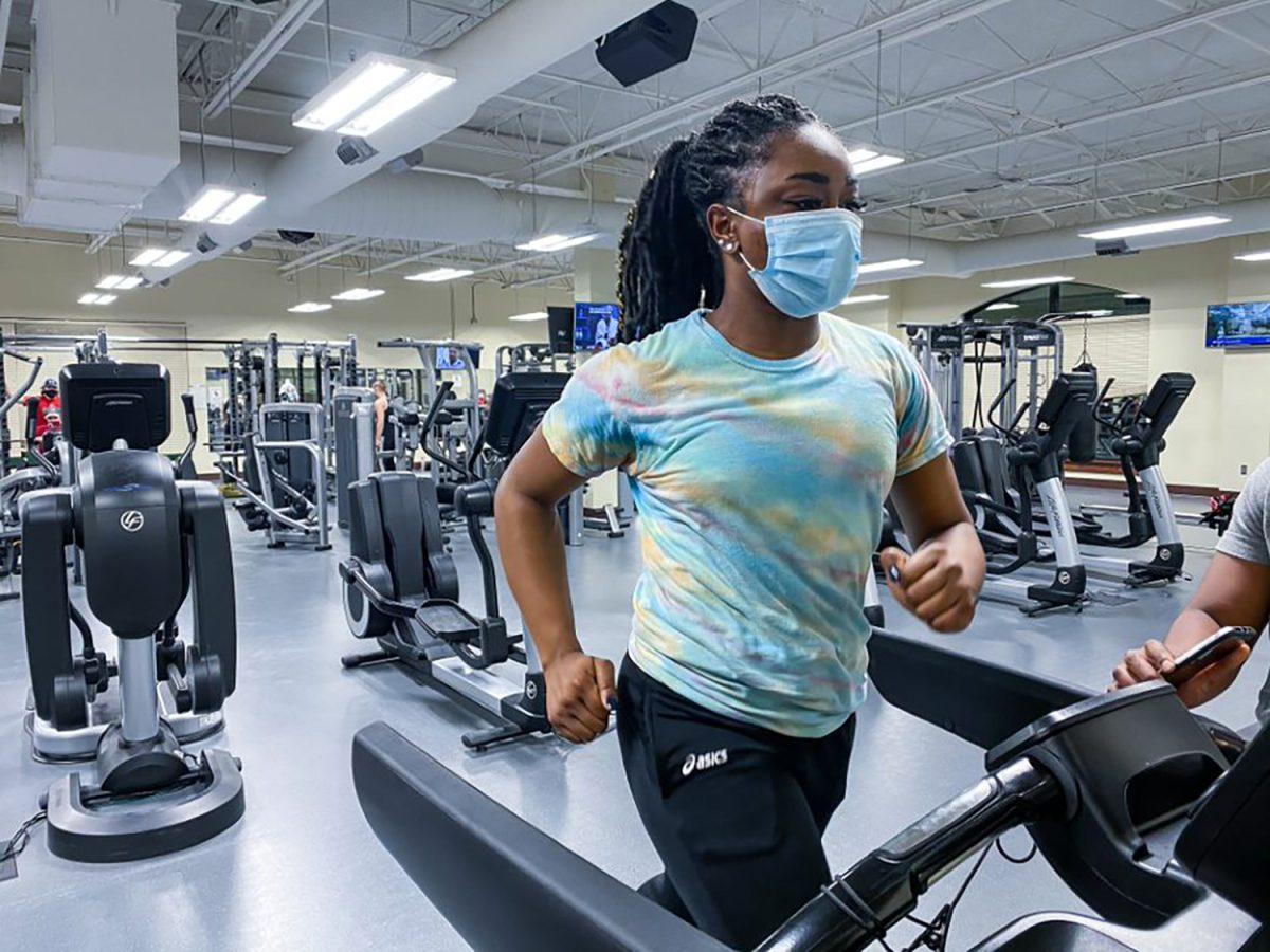 Talia Rawls and Giovanni Burk working out together in the Murphy Recreation Center weight room.  