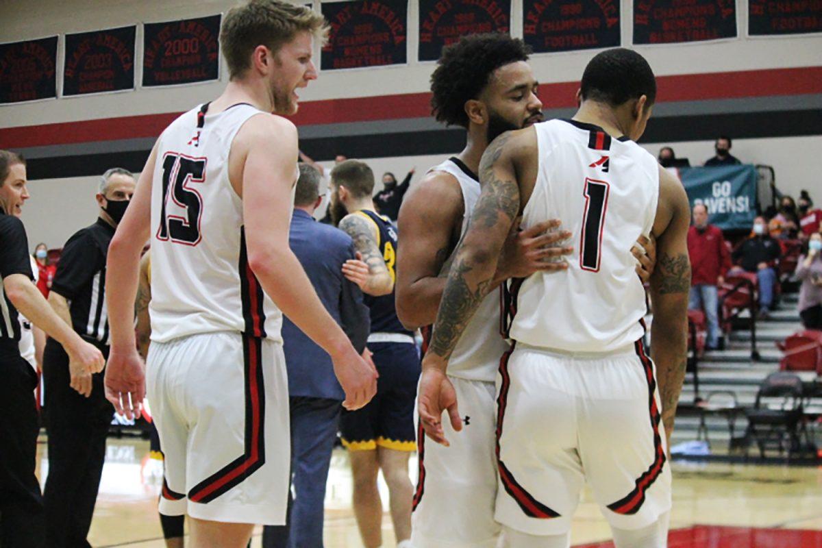 Jaiden Bristol holds back Chris Jackson after Jackson was pushed by Mount Mercy's Dennis McKinney during the Heart Semifinals against Mount Mercy on Feb. 27. Photo by Jason Nick