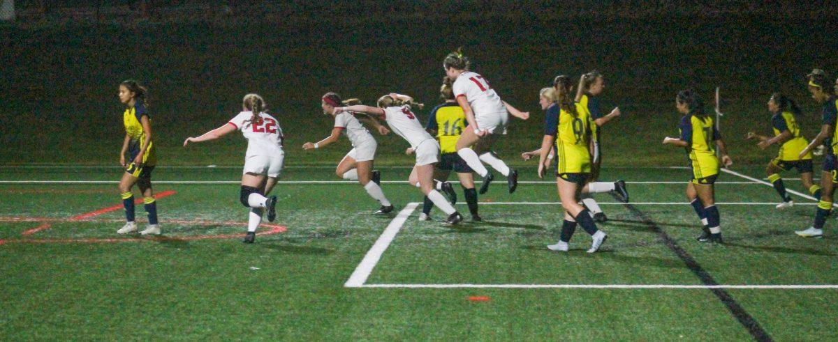  Madison Smith leaps with joy in celebration with her team.