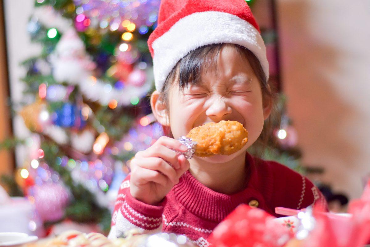 Young Japnese boy eating fried chicken on Christmas. -Photo pulled from arigatojapan.co.jp