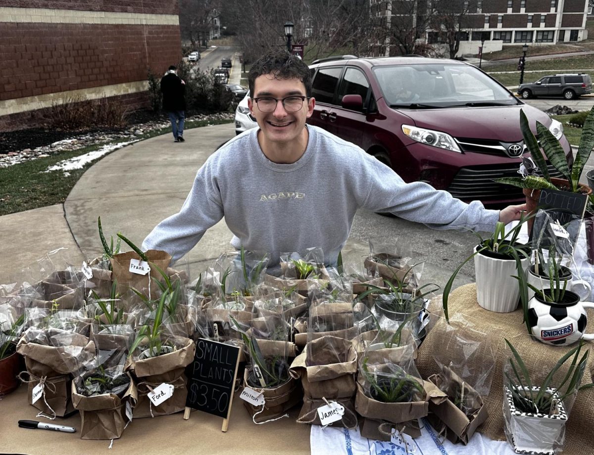 Jones hugs his plants he is giving up for adoption.